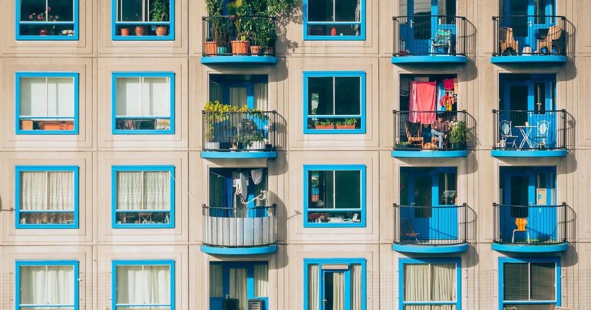 An apartment building facade with rows of balconied windows