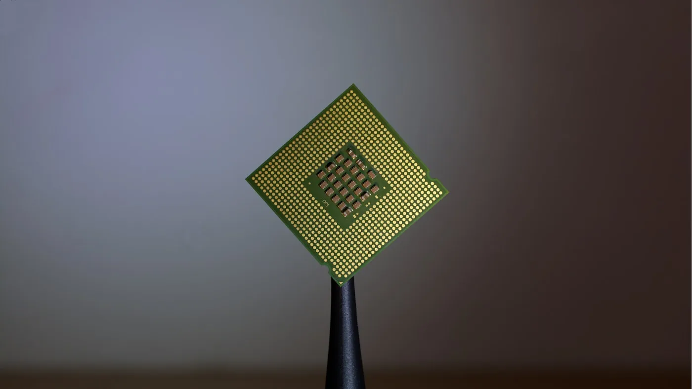 A semiconductor chip balanced on a fingertip