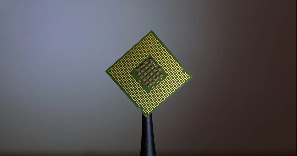 Close-up of a finger touching a computer chip