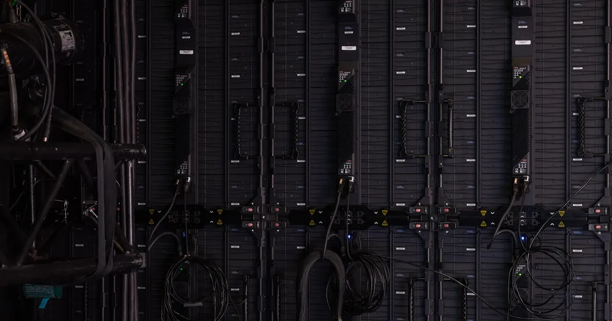 Rows of illuminated server racks inside a large data center