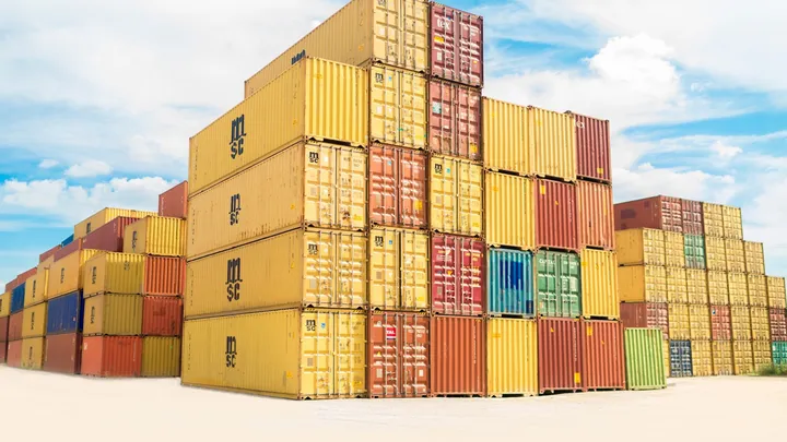 A stack of shipping containers representing software packaging