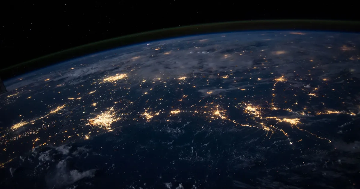 Earth seen from orbit at night with glowing city lights