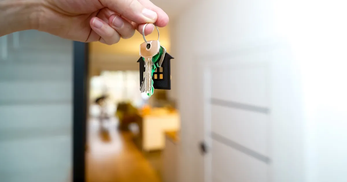 A set of keys on a ring against a plain background