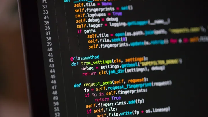 Colorful source code on a dark editor screen