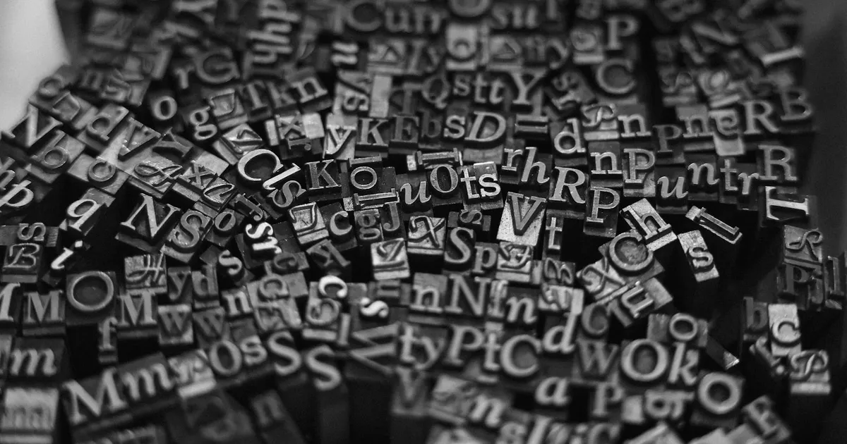 Rows of metal letterpress type blocks used to print text