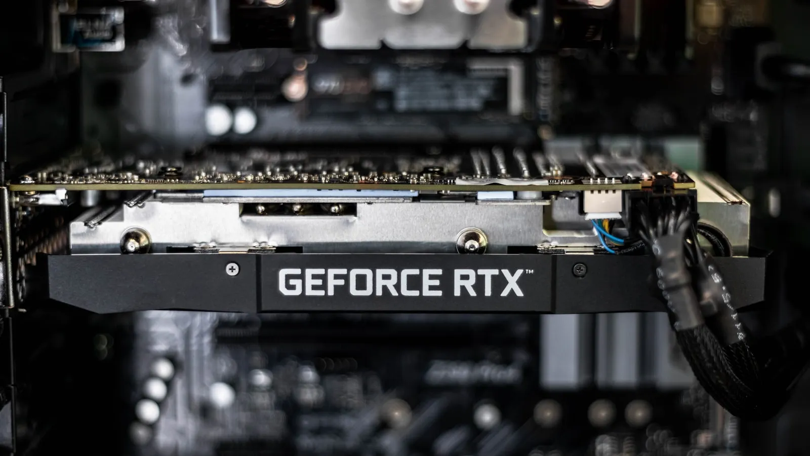 A close-up of an Nvidia data center GPU board in dark lighting