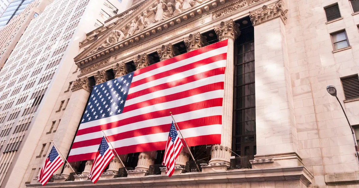 The New York Stock Exchange draped with a large American flag