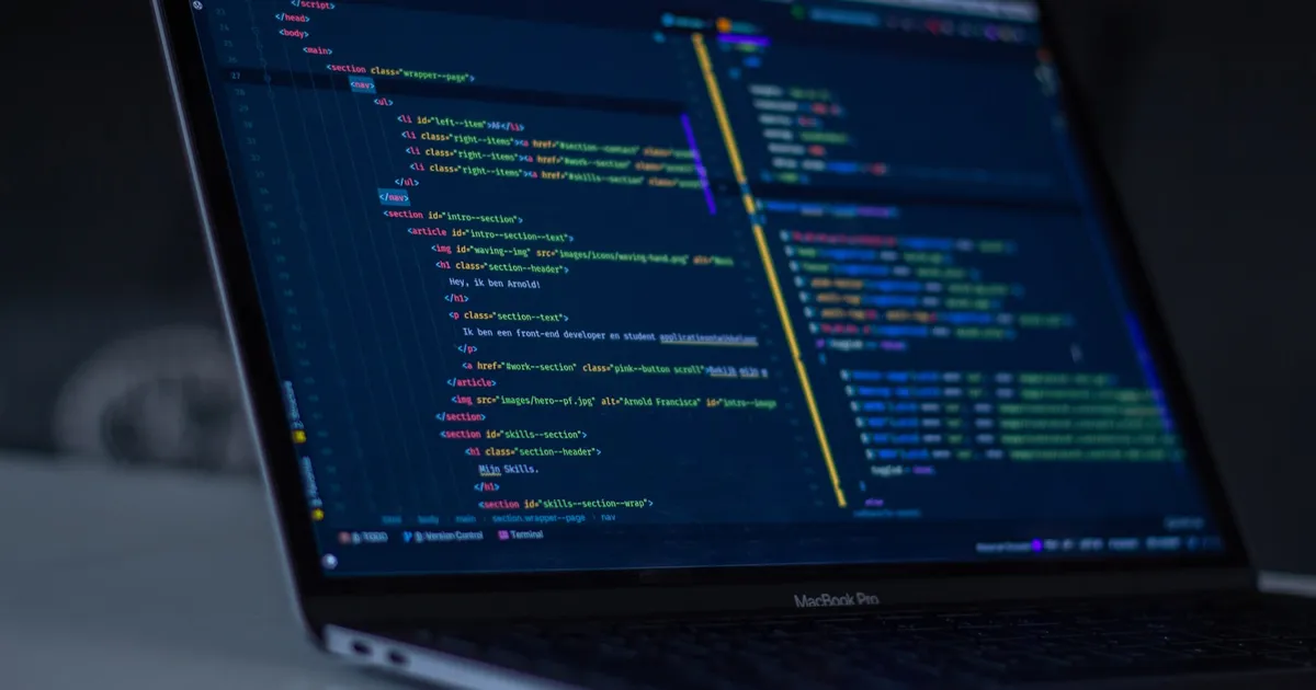 A laptop screen showing lines of code