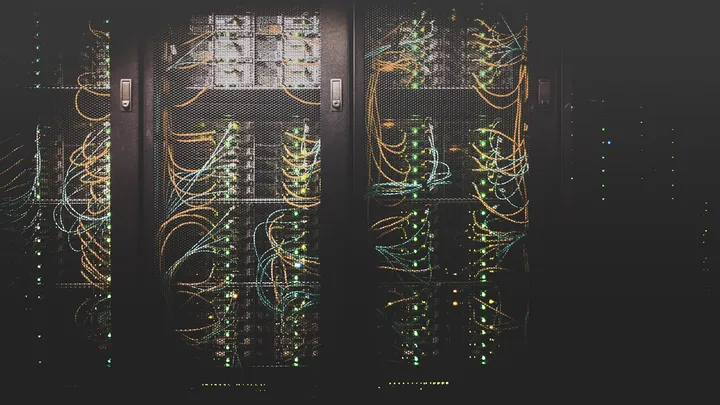 Densely cabled server racks in a data center, representing AI server infrastructure
