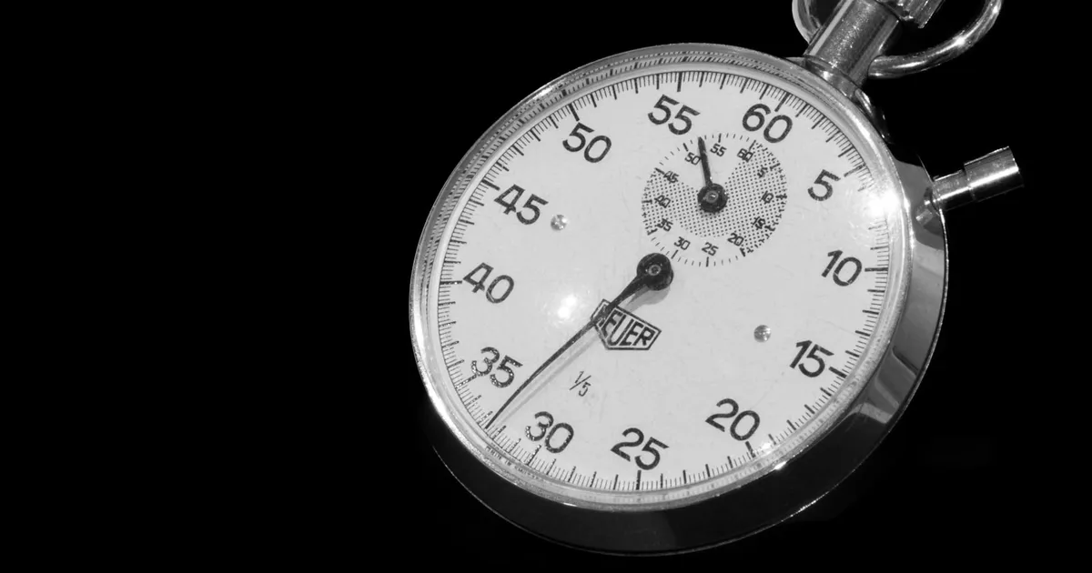 A classic stopwatch face on a black background