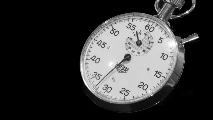 A classic stopwatch face on a black background